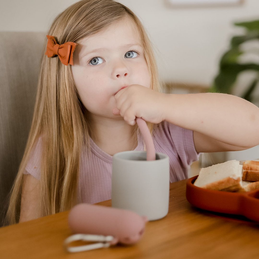 young girl drinking from Grip Cup